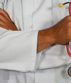 doctor holding red stethoscope