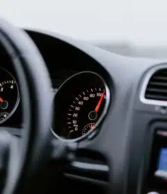 black vehicle dashboard with speedometer on 100